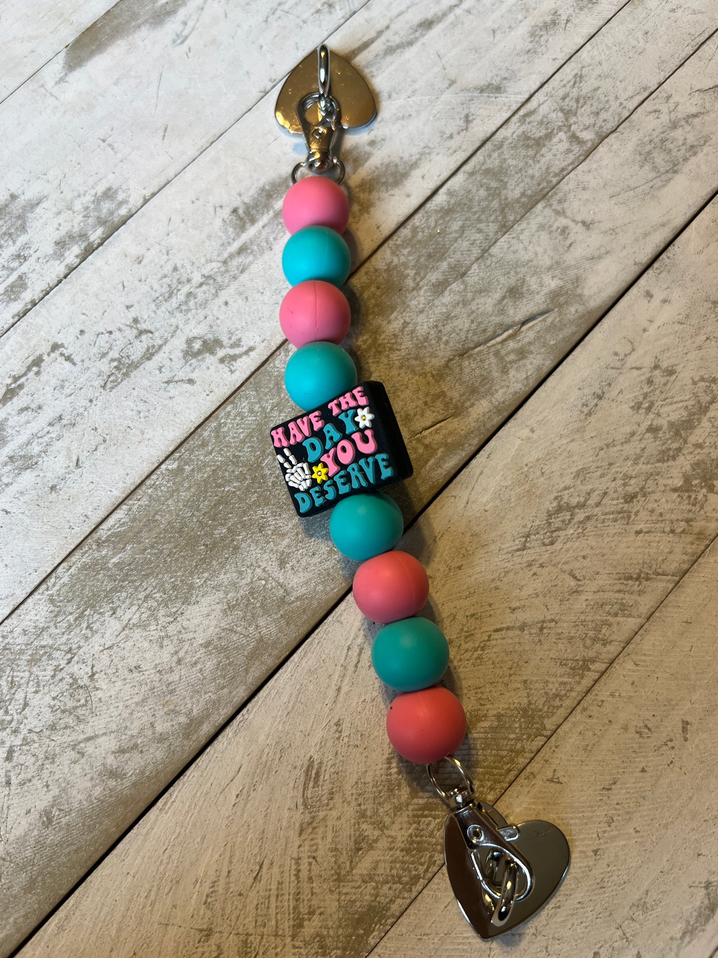 Have the day you deserve phone strap